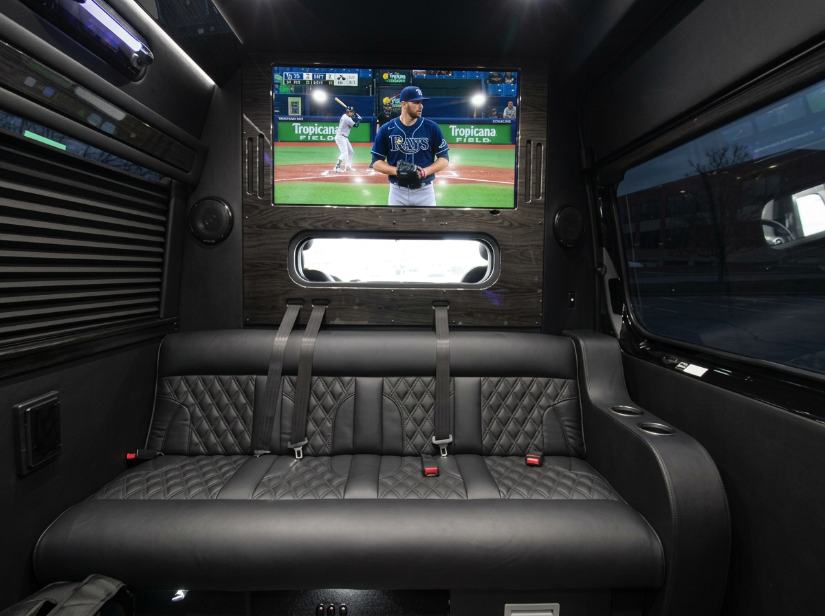 Rays game on the TV above the rear leather bench inside the Lally Limo Sprinter