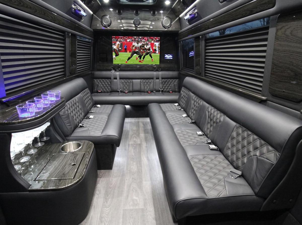 Inside the Lally Limo Sprinter: quilted leather side benches, lit bar and a Bucs game on the rear TV